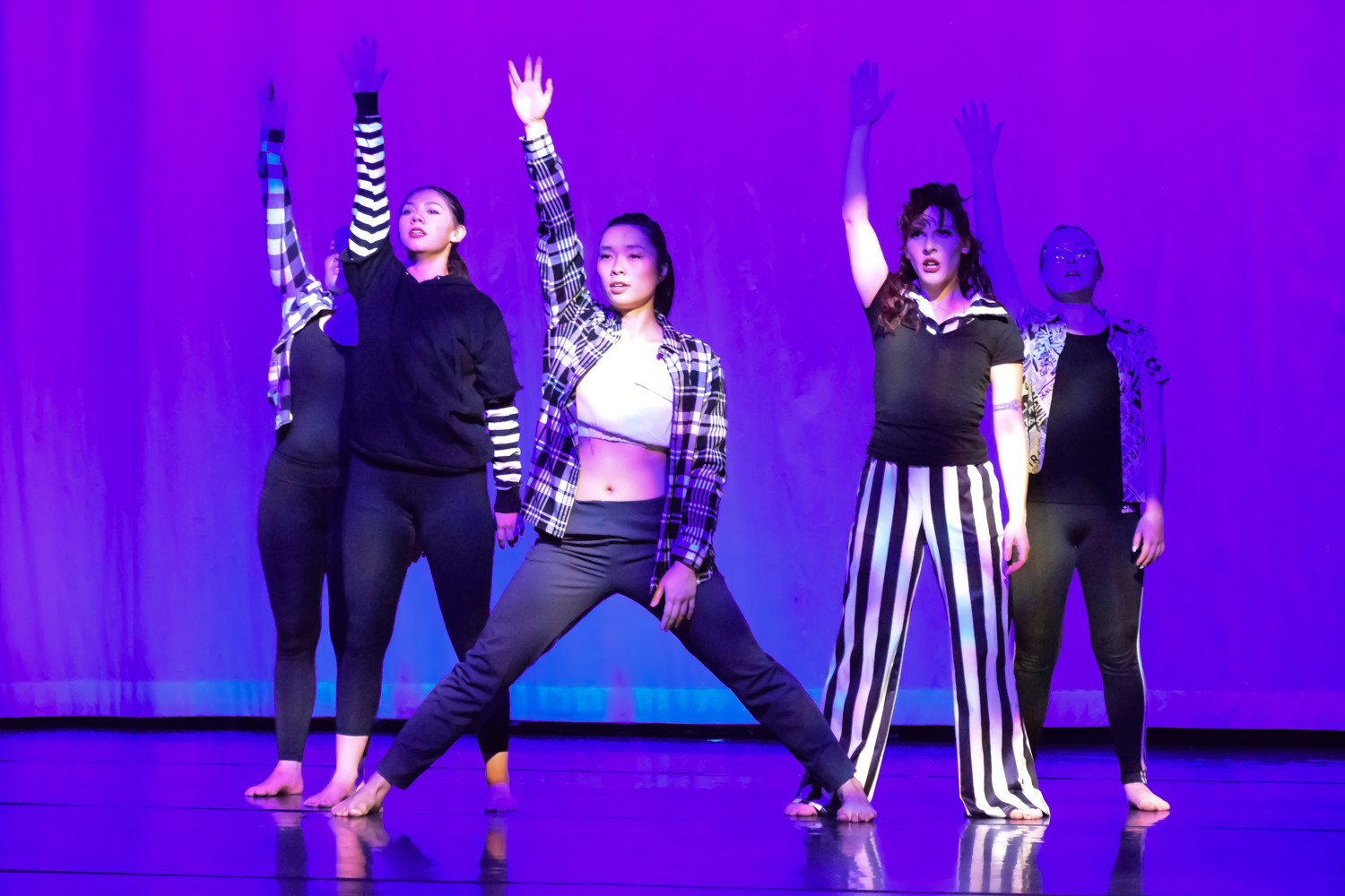 PPSC dance company performing a modern dance piece with spoken word. They're dressed in solid and patterned black and white clothes