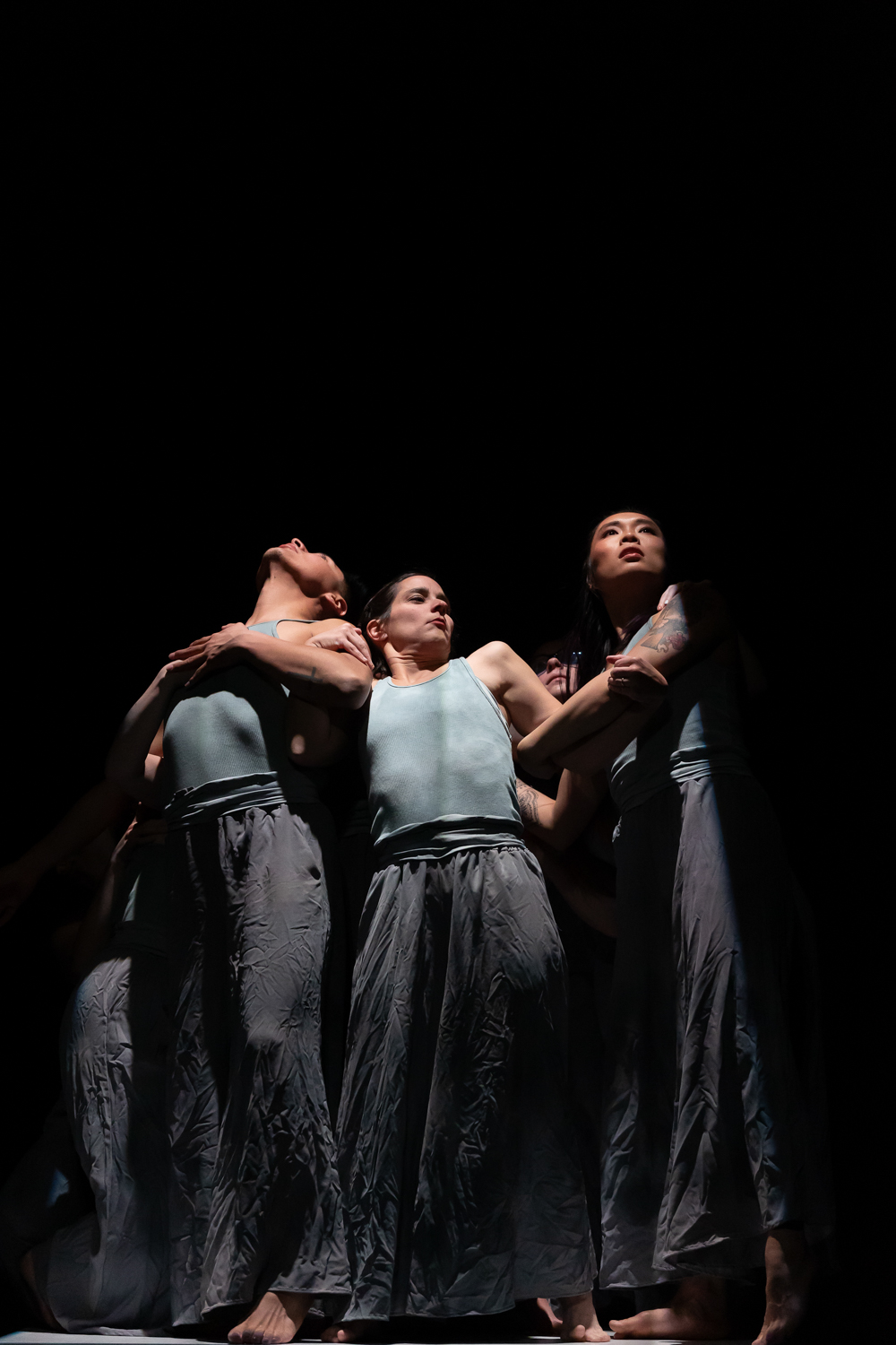 Nicole Leung performing a modern dance piece with Ormao Dance Company members on a platform, choreographed by Jan Johnson