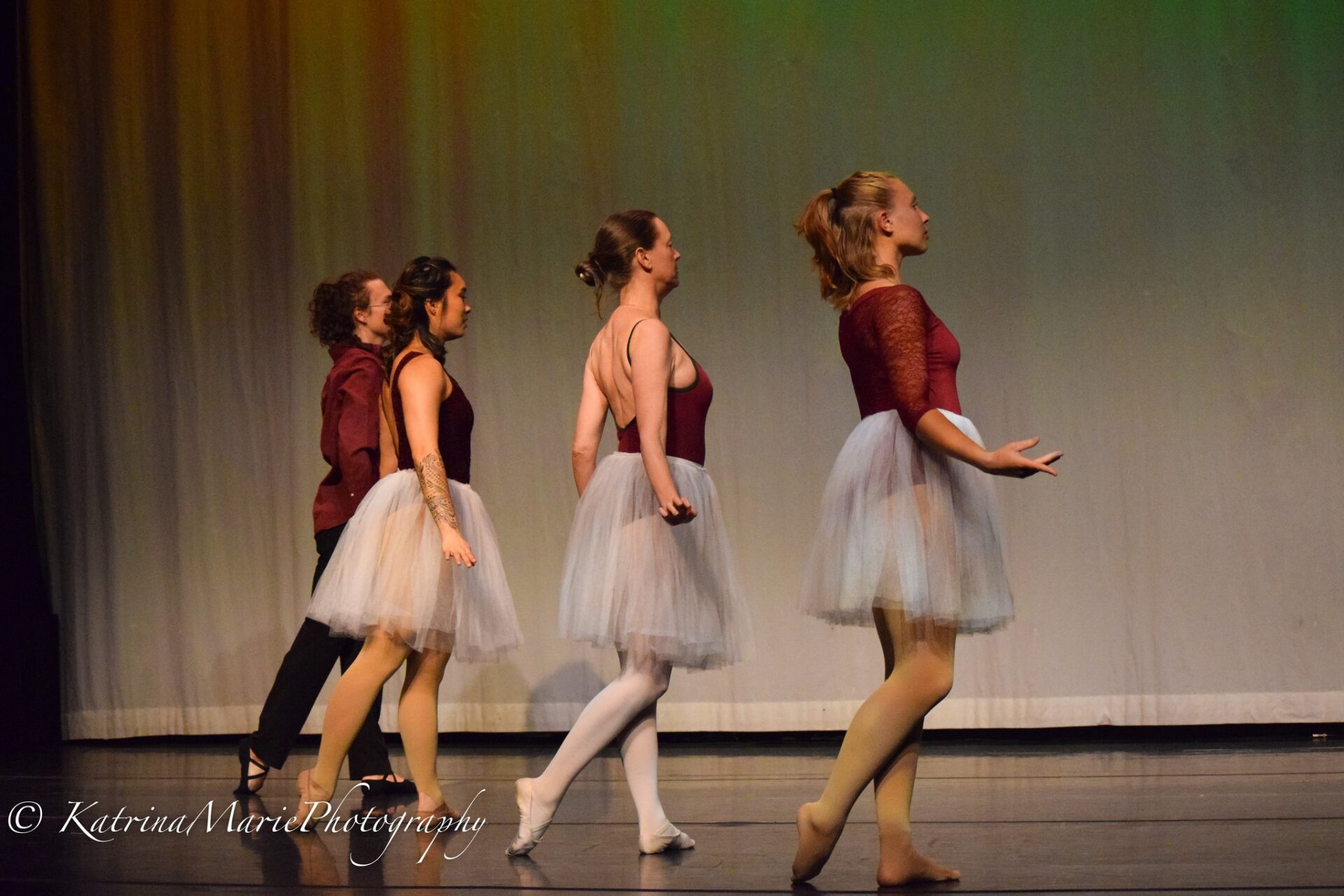 PPSC ballet class performing on stage in red leotards with flowy white skirts
